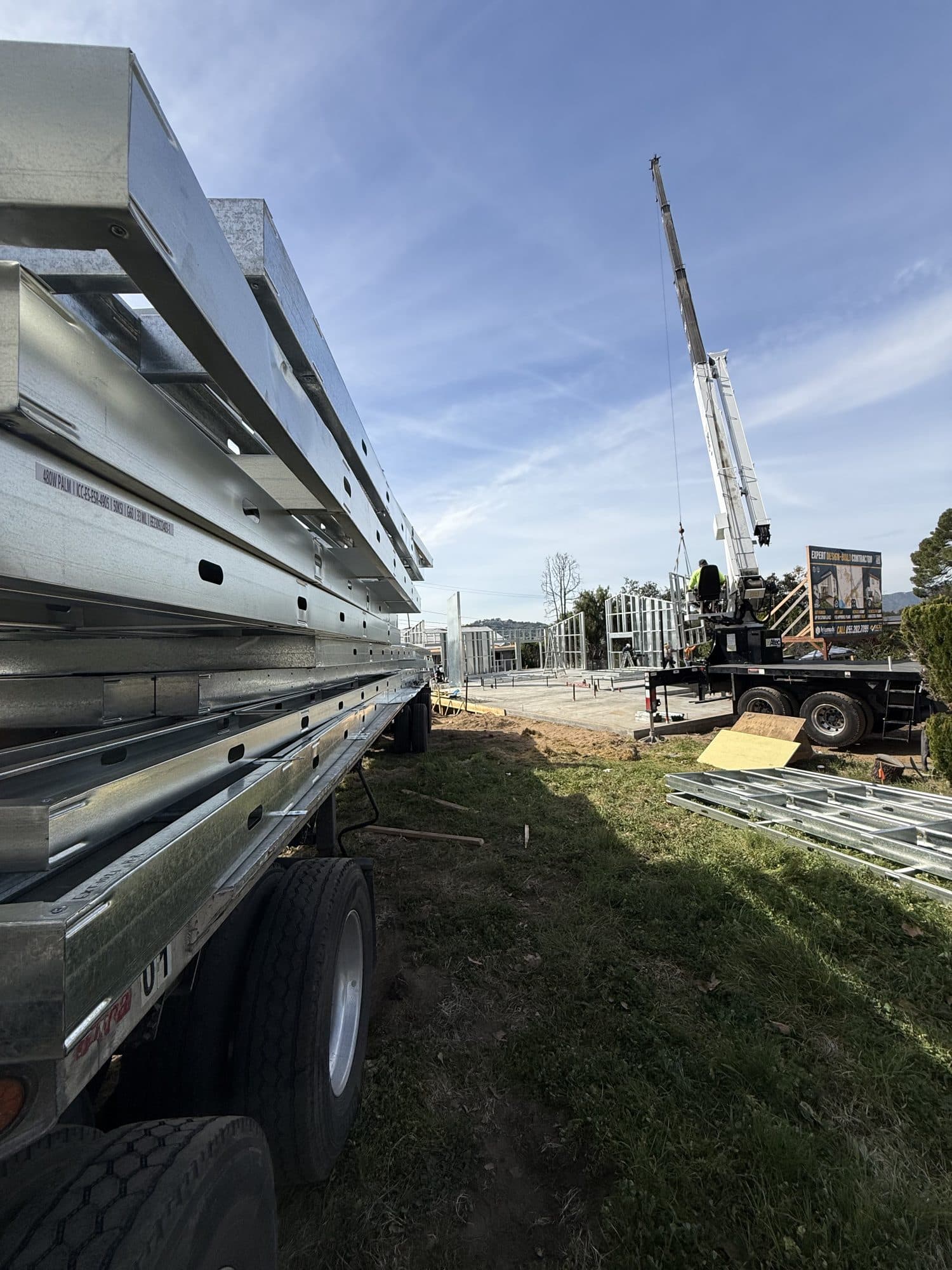 The panelized light gauge steel kit of parts arriving by flatbed at the 480 West Palm site.