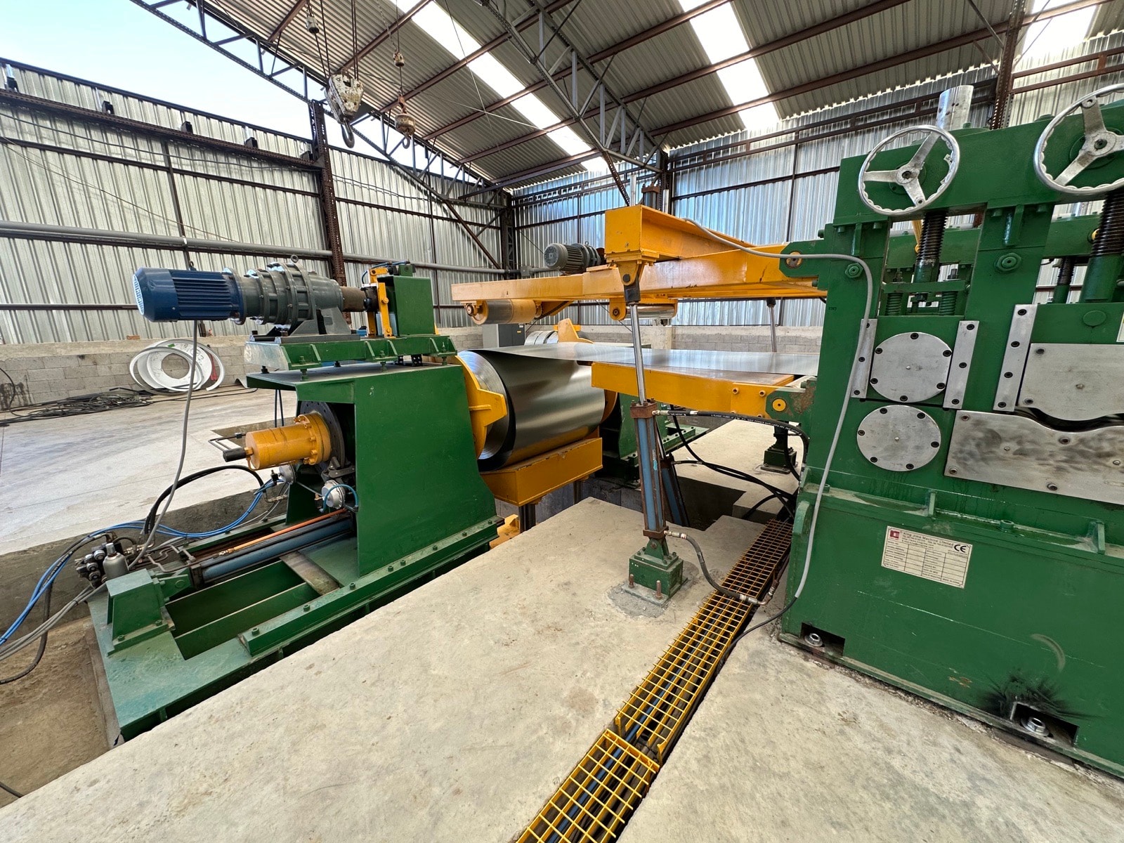 A slitting line with an overhead gantry crane in the light gauge steel plant.