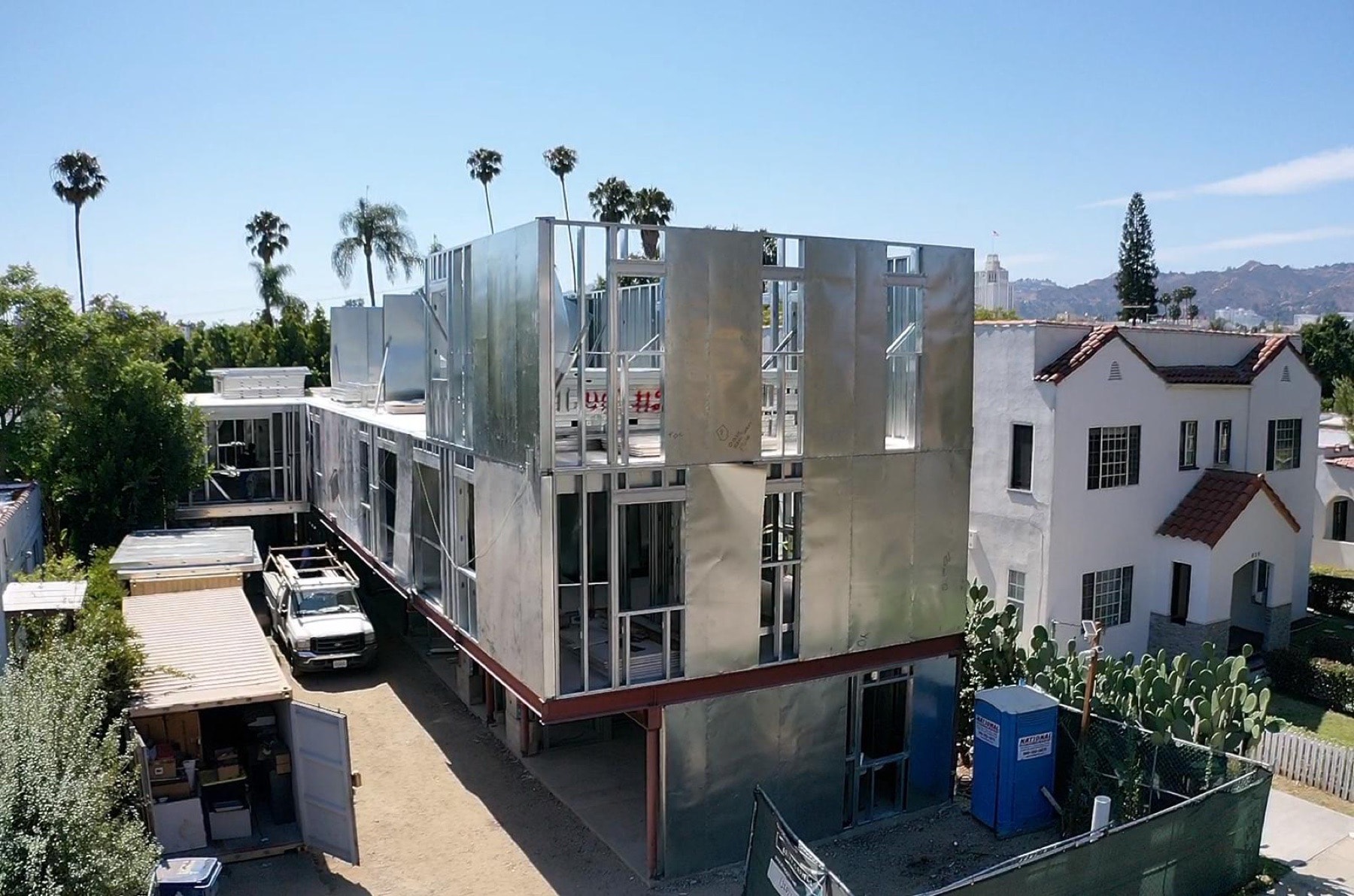 Aerial of a three-story panelized light gauge steel multifamily infill building under construction in a Los Angeles neighborhood (823 North June Street).
