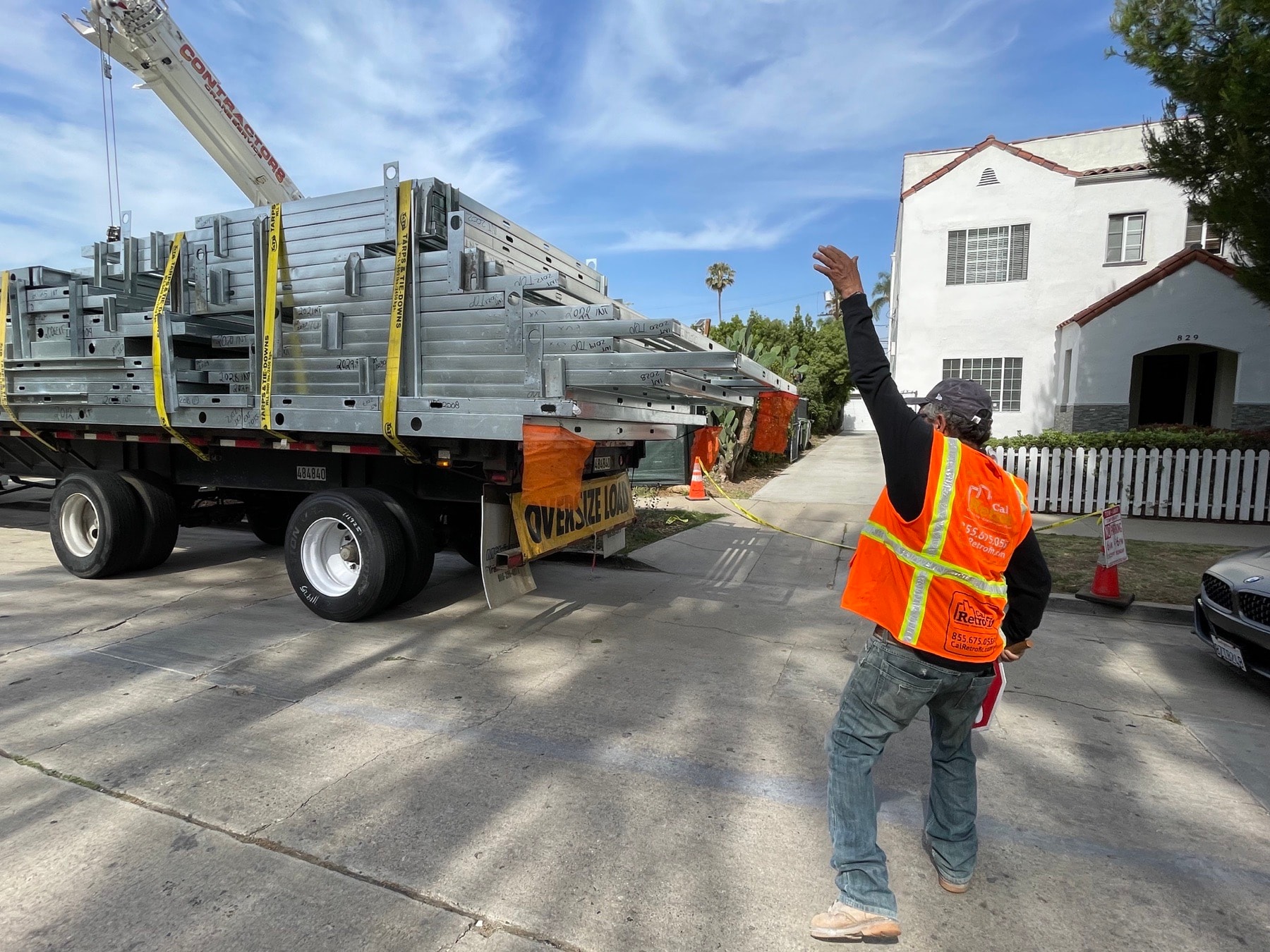 Panelized light gauge steel wall sections delivered by flatbed truck to the 823 North June Street infill site.