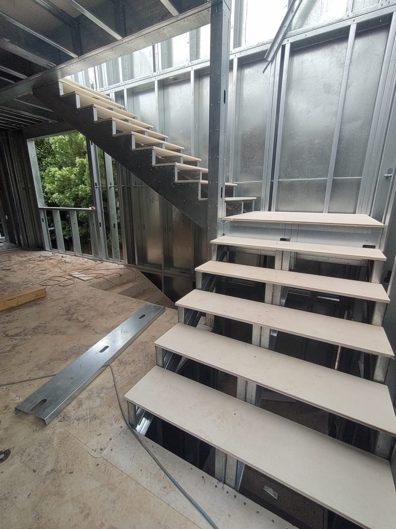 Steel stair and light gauge steel framing inside the 823 North June Street infill build.