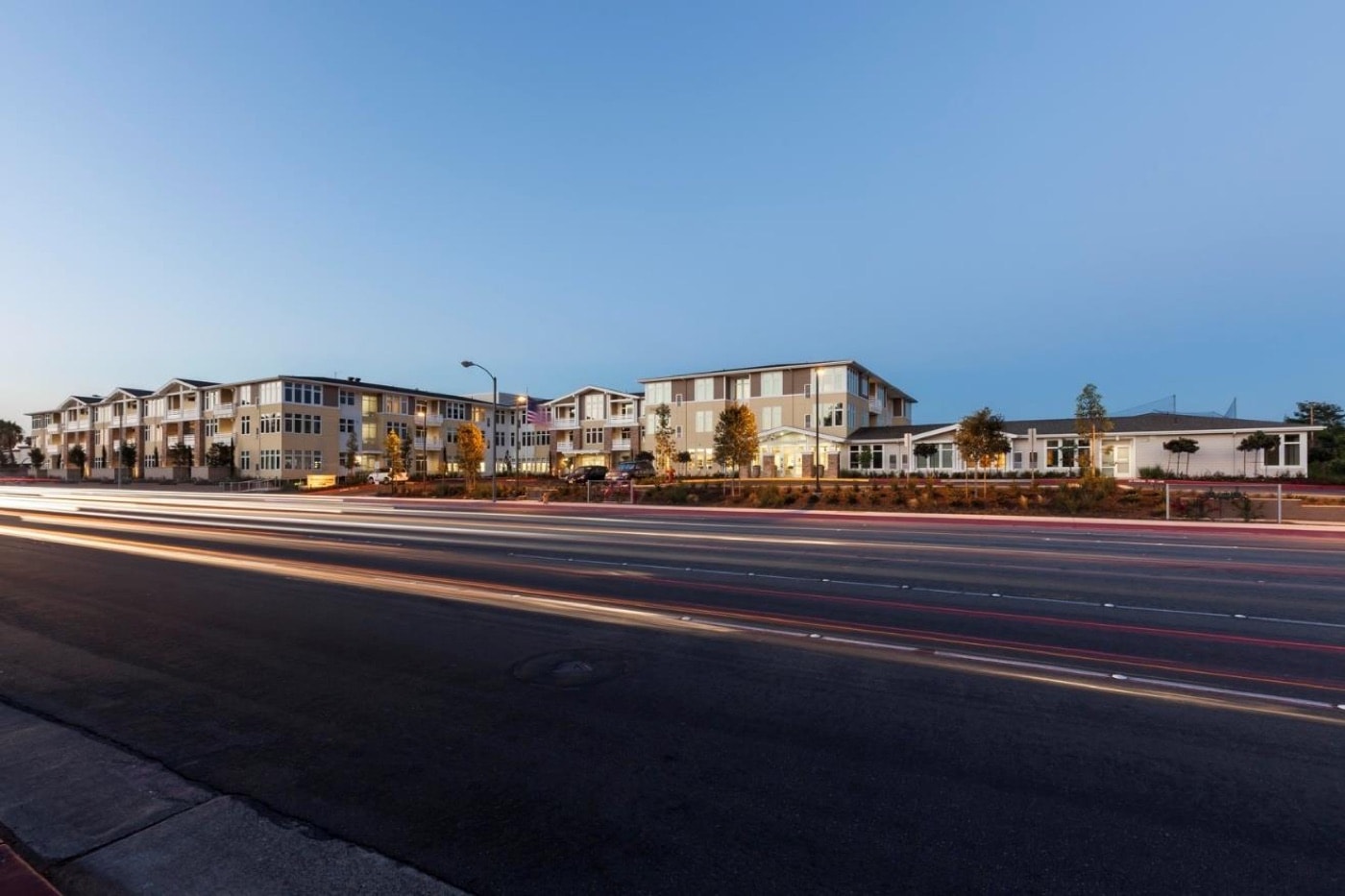 The completed Merrill Gardens senior living facility in Huntington Beach at dusk.
